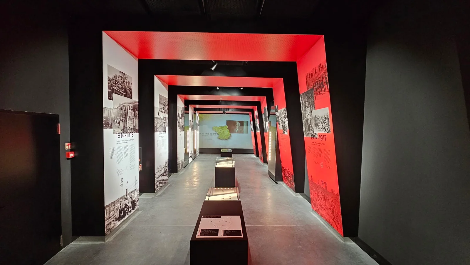Exhibition corridor with red-lit archways