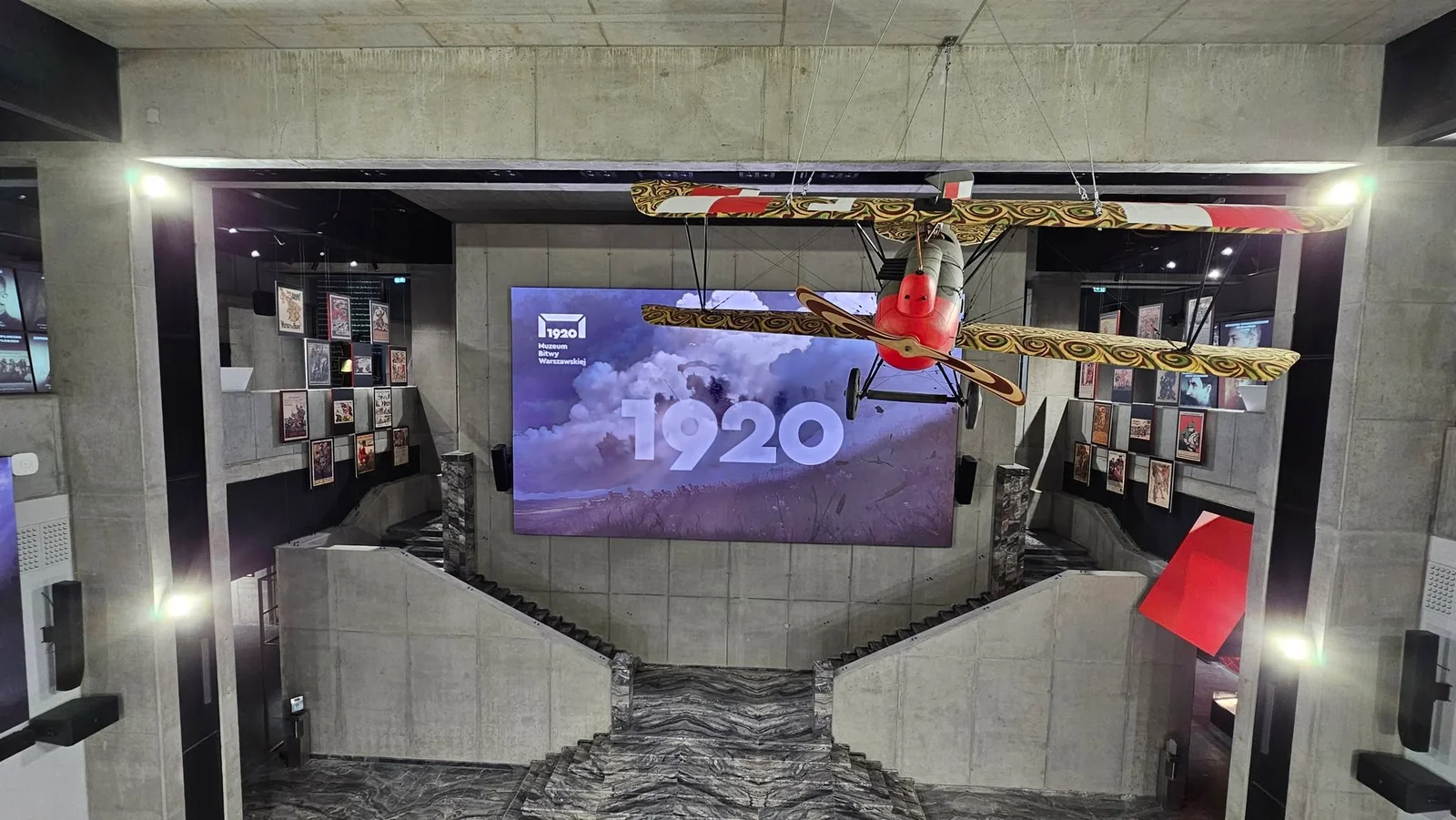 The museum atrium, with the main screen, suspended biplane and speaker array