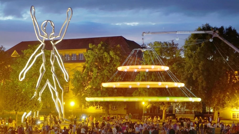 The light installation beside Munich's Walking Man sculpture